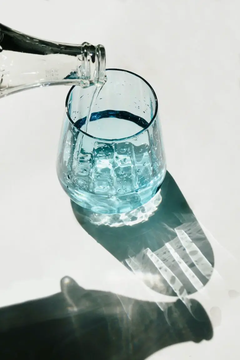 Person Pouring Water on Clear Drinking Glass