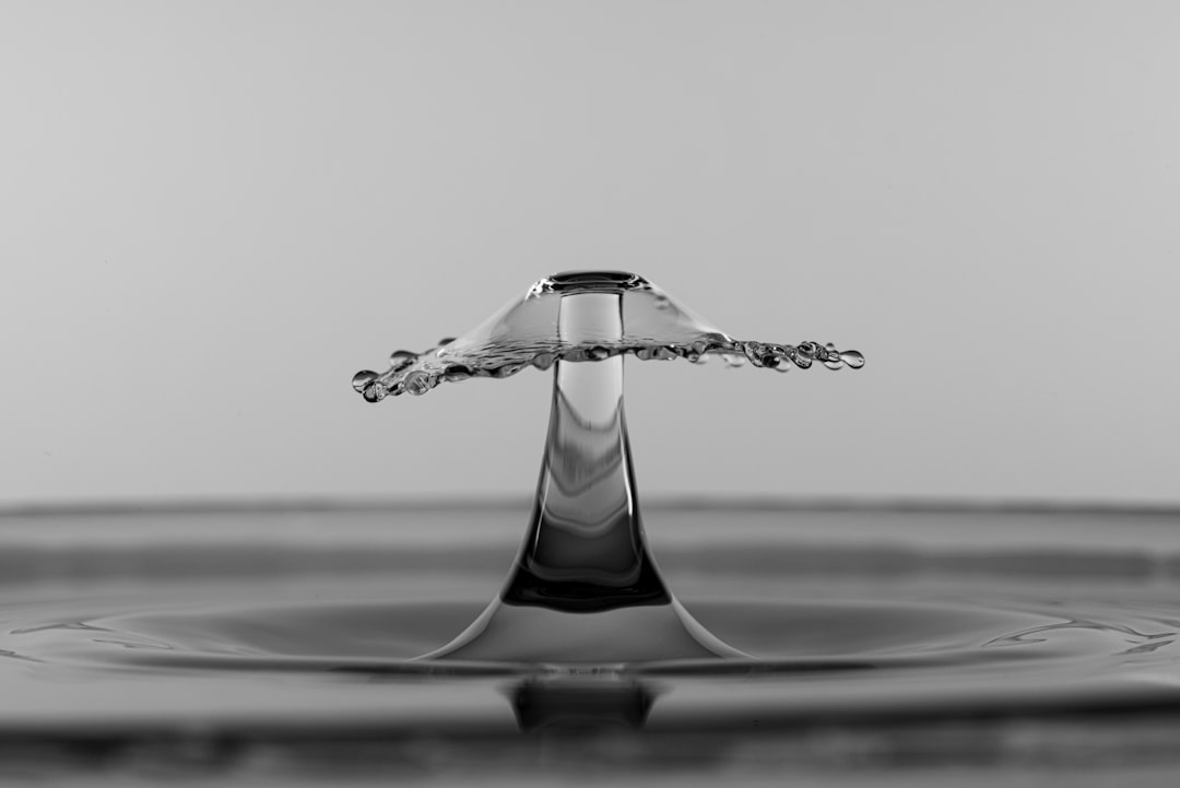 silver heart pendant on table
