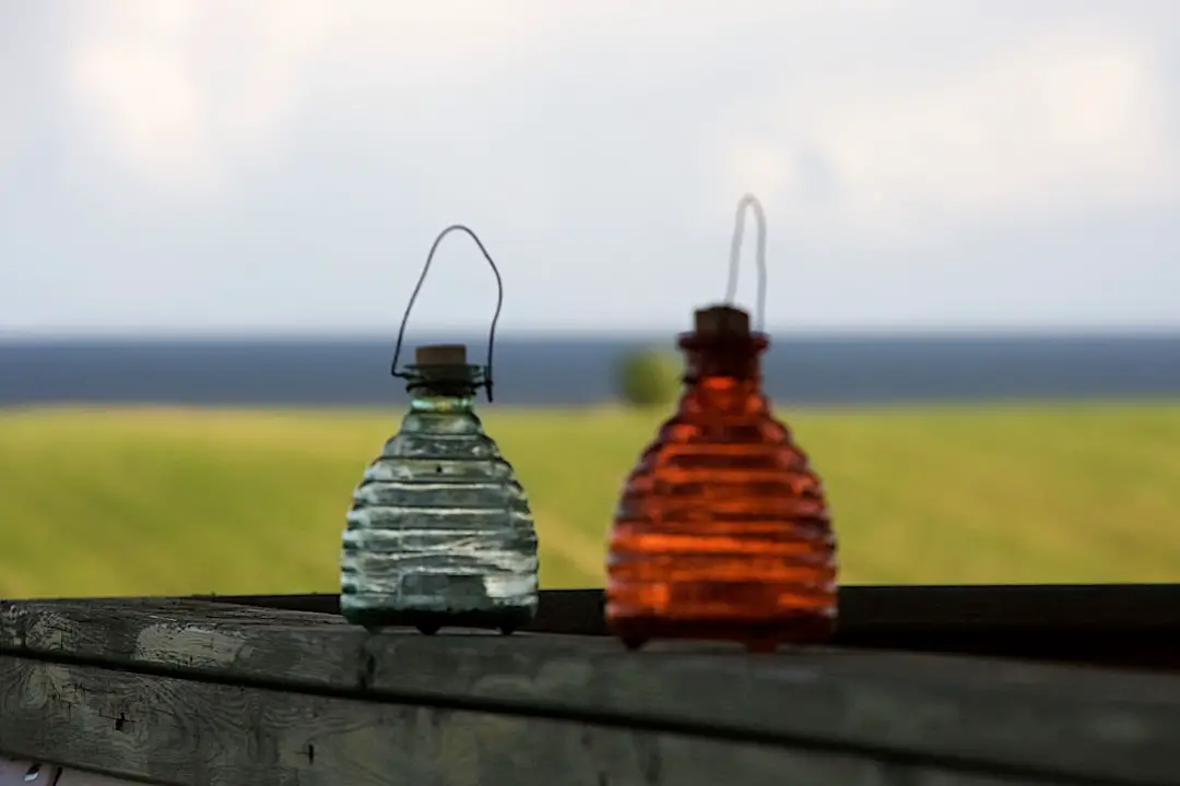 three clear glass bottles on black wooden table